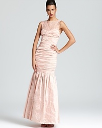 Boasting delicate lace details and a dropwaist silhouette, BCBGMAXAZRIA's feminine gown makes a grand entrance. Boasting delicate lace details and a dropwaist silhouette, BCBGMAXAZRIA's feminine gown makes a grand entrance.