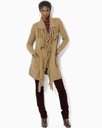 Infused with rustic charm, a soft knit sweater is crafted with a chic open placket and finished with knotted fringe trim. Infused with rustic charm, a soft knit sweater is crafted with a chic open placket and finished with knotted fringe trim.