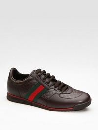 Lace-up sneaker in micro guccissima and smooth leathers with signature green/red/green web. Rubber sole Made in Italy 