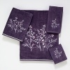 Luxurious sheared velour towel is embellished with a large intricately embroidered silver and lilac botanical motif. Finished with a coordinating silver cord.