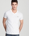 Hip trend-right stripes and a slim-fitting silhouette make Lacoste's V-neck tee an essential for your collection.