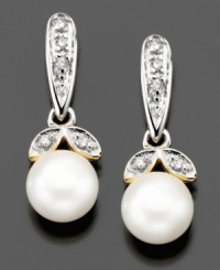 Sunny cultured freshwater pearls (6mm) are nestled between two petals of diamond accents on these beautiful drop earrings crafted in 14k gold and sterling silver. Approximate drop: 1/2 inch.