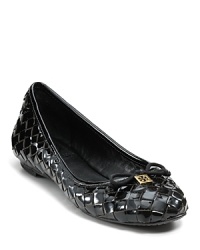 Gleaming woven leather, topped with a Tory Burch logo and slim bow, are a chic play on autumn's texture obsession. Gleaming woven leather, topped with a Tory Burch logo and slim bow, are a chic play on autumn's texture obsession.