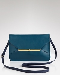 A sleek and compact Tory Burch crossbody is dressed up in rich leather. A magnetic flap opens to functional interior pockets. A sleek and compact Tory Burch crossbody is dressed up in rich leather. A magnetic flap opens to functional interior pockets.