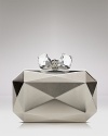 A bolder-is-better nighttime statement piece: this Overture Judith Leiber clutch features a faceted metal exterior, detailed with a bow ornament. An interior holds your smartphone and life's little essentials.