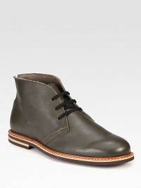 Leather lace-up chukka with contrast piping and stitching along the sole and a durable rubber sole for added support.Leather upperLeather liningPadded insoleRubber soleImported Leather lace-up chukka with contrast piping and stitching along the sole and a durable rubber sole for added support.Leather upperLeather liningPadded insoleRubber soleImported