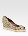 Signature GG fabric wedge with a rope-covered platform, peep toe and buckle adornment. Self-covered wedge, 3 (75mm)Rope-covered platform, 1 (25mm)Compares to a 2 heel (50mm)GG printed fabric upperLeather liningRubber solePadded insoleMade in ItalyOUR FIT MODEL RECOMMENDS ordering one half size up as this style runs small. 