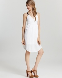 A breezy white Volcom dress gets a dose of attitude from black straps and an exposed back zipper, taking this beachy look into after hours when the bonfire lights up. A breezy white Volcom dress gets a dose of attitude from black straps and an exposed back zipper, taking this beachy look into after hours when the bonfire lights up.