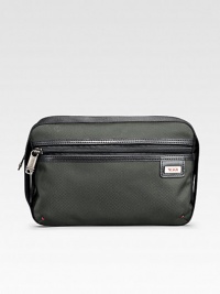 A soft, versatile travel essential design to sit on the counter or hang from a fixture in signature ballistic nylon. Zip closure Elastic loops for hanging Anti-bacterial lining Nylon with leather accents 9½W X 6½H X 4D Imported A soft, versatile travel essential design to sit on the counter or hang from a fixture in signature ballistic nylon. Zip closure Elastic loops for hanging Anti-bacterial lining Nylon with leather accents 9½W X 6½H X 4D Imported