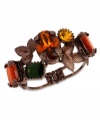 Falling leaves for the season. This lovely bangle bracelet from Betsey Johnson changes your color with topaz and green crystal gems and brown tone leaves. Crafted in brown tone mixed metal. Approximate length: 7-1/2 inches. Approximate diameter: 2-3/8 inches.