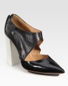 Elevated by a contrasting heel and island platform, this lustrous leather pump finishes the look with a cutout upper, point toe and exposed back zipper. Self-covered heel, 4 (100mm)Island platform, ½ (15mm)Compares to a 3½ heel (90mm)Leather upperPoint toeExposed back zipperLeather liningLeather and rubber solePadded insoleImportedOUR FIT MODEL RECOMMENDS ordering one half size up as this style runs small. 