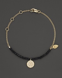A diamond circle charm and black spinel gems great dramatic beauty on a 14K. yellow gold chain. By Meira T. A diamond circle charm and black spinel gems great dramatic beauty on a 14K. yellow gold chain. By Meira T.