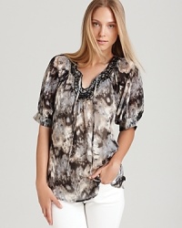 A monochrome palette and metallic embellishments lend modern inspiration to a Shiloh770 top. Team with white denim for a city-chic approach to bohemian style. A monochrome palette and metallic embellishments lend modern inspiration to a Shiloh770 top. Team with white denim for a city-chic approach to bohemian style.