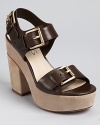 Bold buckles make an impression on KORS Michael Kors' Newman sandals, a chunky silhouette rendered in earthy teak-hued leather and finished with the softest suede.