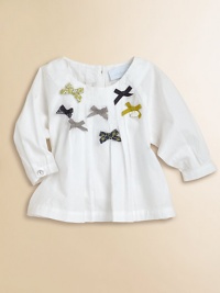A dreamy peasant-style blouse with lace and grosgrain bows and a mother-of-pearl adornment.Scoop neckBack button closureLong sleeves with button cuffsFront and back pleatsCottonMachine washMade in France Please note: Number of buttons may vary depending on size ordered. A dreamy peasant-style blouse with lace and grosgrain bows and a mother-of-pearl adornment.Scoop neckBack button closureLong sleeves with button cuffsFront and back pleatsCottonMachine washMade in France Please note: Number of buttons may vary depending on size ordered.
