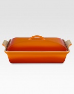 Crafted from heavy stoneware, Le Creuset cookware is the ultimate ingredient for chefs and home cooks worldwide. With its secure lid, this covered casserole is a convenient choice for transporting dishes to parties and picnics. Not only does the lid provide an effective moisture and heat lock for the dish, but it prevents spills and protects its contents.