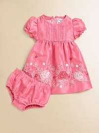 The elegant sheen and subtle texture of shantung define this charming party dress with sweet embroidered flowers abloom on the full skirt.Round necklineShort puffed sleeves with lacy smocked ruffled cuffsBack zip closeHorizontal tuxedo-pleated bodiceEmpire waistGathered full skirt with embroiderySatin liningMatching bloomers with elasticized waist and leg openingsPolyesterMachine washImported The elegant sheen and subtle texture of shantung define this charming party dress with sweet embroidered flowers abloom on the full skirt.Round necklineShort puffed sleeves with lacy smocked ruffled cuffsBack zip closeHorizontal tuxedo-pleated bodiceEmpire waistGathered full skirt with embroiderySatin liningMatching bloomers with elasticized waist and leg openingsPolyesterMachine washImported