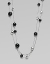 A very long, delicate piece with beautiful round black agate and contrasting sterling silver stations on a link chain, perfect for wearing doubled. Black agateSterling silverLength, about 51Clasp closureImported 