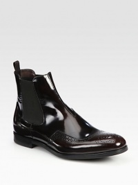 Leather Chelsea boot design with wing-tip detail and side goring.Leather upperLeather liningRubber soleMade in Italy Leather Chelsea boot design with wing-tip detail and side goring.Leather upperLeather liningRubber soleMade in Italy