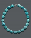 Add a little color and class. This stunning carved necklace adds a vivid pop to your look with bright turquoise beads (14 mm) and a sterling silver clasp. Approximate length: 18 inches.