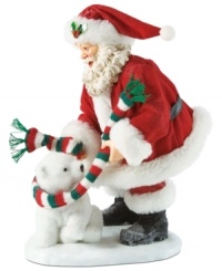 Bundle up! This adorable figurine captures Santa wrapping a polar bear in a festive colored scarf. Bundle up! This adorable figurine captures Santa wrapping a polar bear in a festive colored scarf.