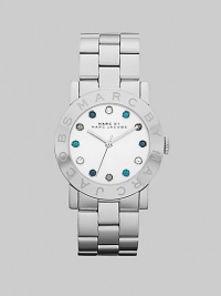 A sleek stainless steel style with multicolored stone markers for a pop of color. Quartz movementWater resistant to 5 ATMRound stainless steel case, 36mm (1.4)Logo etched bezelSilver dialMulticolored glass stone hour markersSecond hand Stainless steel link braceletImported A sleek stainless steel style with multicolored stone markers for a pop of color. Quartz movementWater resistant to 5 ATMRound stainless steel case, 36mm (1.4)Logo etched bezelSilver dialMulticolored glass stone hour markersSecond hand Stainless steel link braceletImported