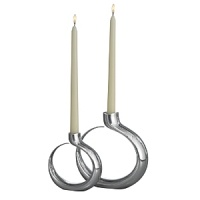 With playfully curled bases of shining alloy, these candlesticks appear almost weightlessnearly floating on airas the flames flicker toward the night sky. But in fact, these pieces are deceptively sturdy; thats the genius of award-winning designer Neil Cohen, whose creations are brilliantly engaging, and fabulously functional. With playfully curled bases of shining alloy, these candlesticks appear almost weightlessnearly floating on airas the flames flicker toward the night sky. But in fact, these pieces are deceptively sturdy; thats the genius of award-winning designer Neil Cohen, whose creations are brilliantly engaging, and fabulously functional.