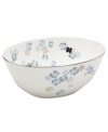 Breezy florals scatter on the white bone china of this Water Blossoms vegetable bowl, suffusing your table with effortless grace. With shimmering platinum petals and banding for an especially pretty table. From Martha Stewart Collection.