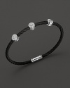 From the Celtic Noir Collection, a stackable bangle in white gold and black PVD cable with diamond stations. Designed by Charriol.