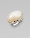 A shimmering mother of pearl cabochon, edged in diamonds, on sterling silver.Diamonds, .11 tcw Mother of pearl cabochon Sterling silver Width, about 1¼ Imported