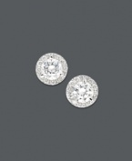 Traditional diamond earrings with an extra touch of sparkle. Round-cut diamonds are encircled by a halo of round-cut diamonds (1 ct. t.w.). Set in 14k white gold. Approximate diameter: 5 mm.