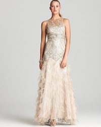 Make an unforgettable appearance in this beaded Sue Wong gown, crafted with an utterly dramatic skirt detailed with petal trim and ostrich feathers. Make an unforgettable appearance in this beaded Sue Wong gown, crafted with an utterly dramatic skirt detailed with petal trim and ostrich feathers.