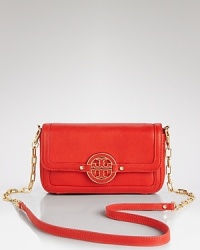 This leather Tory Burch crossbody is dressed up in the brand's signature leather-inset logo. The front flap opens to reveal a lined interior with 3 card slots.