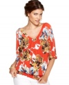 Style&co.'s sizzling new take on the classic peasant top features a bold print, bright color and a unique V-neckline in front and back!