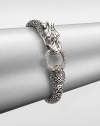 From the Naga Collection. This zodiac-inspired style from a socially and environmentally responsible brand features sterling silver dragon and a brilliant diamond encrusted hoop. Sterling silverDiamonds, .45 tcwLength, about 7.25Hinged clasp closureImported