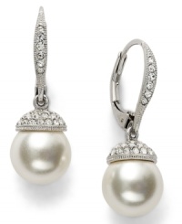 Sheer elegance. A polished simulated pearl (10 mm) adorned with crystal accents makes for divine style in Eliot Danori's dramatic drop earrings. Set in rhodium-plated mixed metal. Approximate drop: 1 inch. Sheer elegance. A polished simulated pearl (10 mm) adorned with crystal accents makes for divine style in Eliot Danori's dramatic drop earrings. Set in rhodium-plated mixed metal. Approximate drop: 1 inch.