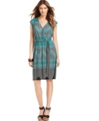 A sleek stretch jersey dress from NY Collection gets the graphic treatment in a colorful allover print, giving its flattering belted silhouette a fresh, modern pop. A sleek stretch jersey dress from NY Collection gets the graphic treatment in a colorful allover print, giving its flattering belted silhouette a fresh, modern pop.
