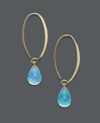 A tropical delight - ocean blue drops in gold transform any look to the exotic. 14k gold oval hoop earrings feature a dazzling, faceted blue topaz teardrop (8-3/4 ct. t.w.). Approximate diameter: 1-1/2 inches. A tropical delight - ocean blue drops in gold transform any look to the exotic. 14k gold oval hoop earrings feature a dazzling, faceted blue topaz teardrop (8-3/4 ct. t.w.). Approximate diameter: 1-1/2 inches.