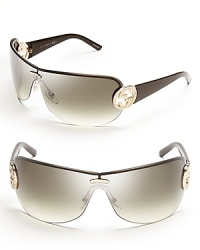 Show off your stunningly chic style in Gucci's shield sunglasses, featuring crystal bridal accents and gradient lenses. Show off your stunningly chic style in Gucci's shield sunglasses, featuring crystal bridal accents and gradient lenses.