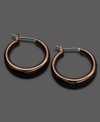 Fossil spices up traditional hoops with a chic ionic brown plating. Earrings crafted in mixed metal. Approximate diameter: 3/4 inches.