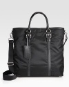 An everyday essential, handsomely crafted in tessuto nylon, trimmed with textured saffiano leather.Snap button closureDouble top handlesAdjustable shoulder strapInterior zip pocketNylon15W x 15H x 7DMade in Italy