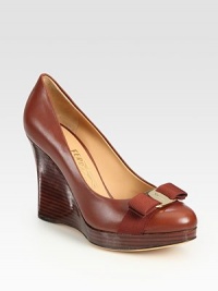 Supple leather forms this comfortable wedge silhouette, topped with a feminine bow. Stacked wooden wedge, 4 (100mm)Covered wooden platform, ½ (15mm)Compares to a 3½ heel (90mm)Leather upperLeather lining and solePadded insoleMade in ItalyOUR FIT MODEL RECOMMENDS ordering one half size up as this style runs small. Supple leather forms this comfortable wedge silhouette, topped with a feminine bow. Stacked wooden wedge, 4 (100mm)Covered wooden platform, ½ (15mm)Compares to a 3½ heel (90mm)Leather upperLeather lining and solePadded insoleMade in ItalyOUR FIT MODEL RECOMMENDS ordering one half size up as this style runs small.