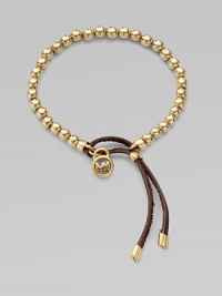 A smooth, beaded design with a logo lock charm and an adjustable leather closure. Goldtone metalDiameter, about 2.5Slip-on style with adjustable leather closureImported A smooth, beaded design with a logo lock charm and an adjustable leather closure. Goldtone metalDiameter, about 2.5Slip-on style with adjustable leather closureImported
