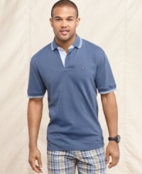 Nothing tops the classic look of this solid polo shirt from Tommy Hilfiger. Nothing tops the classic look of this solid polo shirt from Tommy Hilfiger.