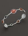 Faceted doublets of clear quartz, almond, smoky quartz and mother-of-pearl in a sterling silver bangle. From the Ippolita Rock Candy Collection.