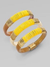 A set of three stunning bangles of natural horn, richly wrapped in brass wire and bright leather cord.Natural cow hornBrassLeatherDiameter, about 2¾Imported A set of three stunning bangles of natural horn, richly wrapped in brass wire and bright leather cord.Natural cow hornBrassLeatherDiameter, about 2¾Imported