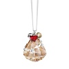 Sparkling Swarovski crystal in a warm golden hue is embellished with silvery metal details, dangling charms and a small jingling bell to create this festive Christmas ornament.