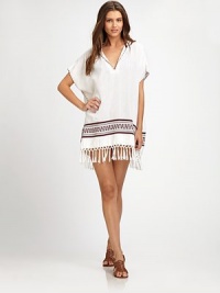 An exotic hooded coverup with exquisite embroidery, tassel details and gorgeous fringe. V-neckShort sleevesTassel detailsCottonDry cleanImported