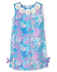 Nothing beats the signature silhouette of a Lilly Pulitzer shift, rendered in a gorgeous floral print with frosting-sweet rosettes at the neck. Nothing beats the signature silhouette of a Lilly Pulitzer shift, rendered in a gorgeous floral print with frosting-sweet rosettes at the neck.