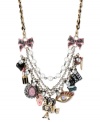 The reel deal. Betsey Johnson takes you to the movies with this frontal statement necklace. Crafted from gold-tone mixed metal and grosgrain ribbon, the necklace screams Action! with a number of glass accent charms. Approximate length: 16 inches + 3-inch extender. Approximate drop: 2-3/4 inches.